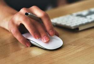 Person clicking a mouse
