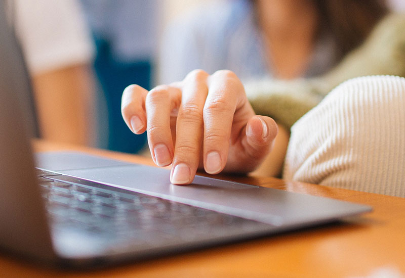 Person using computer touchpad to find tools and resources