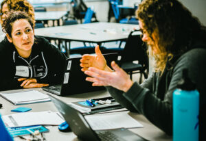 Teachers collaborating with laptop
