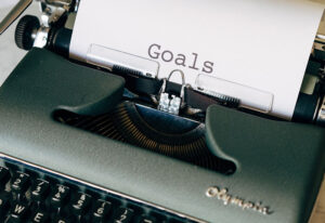 Typewriter with goals written on paper