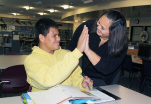 Student and teacher celebrate with a high five