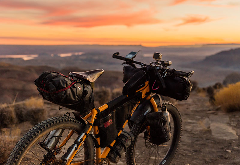 Mountain bike overlooking a valley at sunset