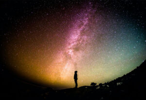 Man looking up into the night sky
