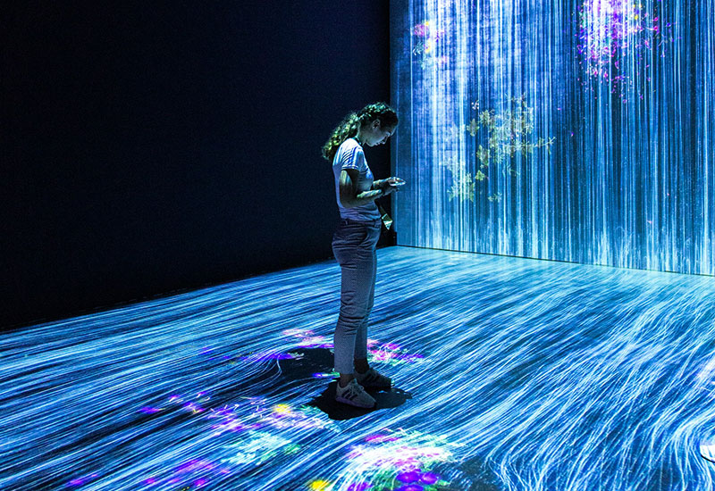 Man standing in front of a wall of LED lights
