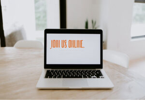 Laptop with phrase, Join us online, displayed on the screen
