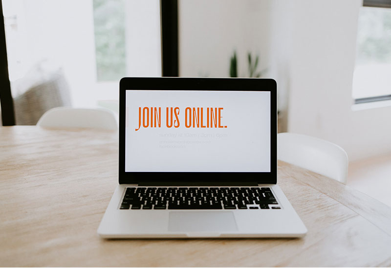 Laptop with phrase, Join us online, displayed on the screen
