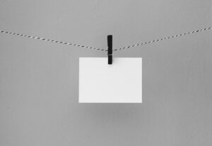 Blank note card hanging on a string by a clothes pin