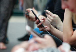 Group of people looking at their mobile phones