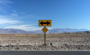 Sign in the desert pointing in two directions