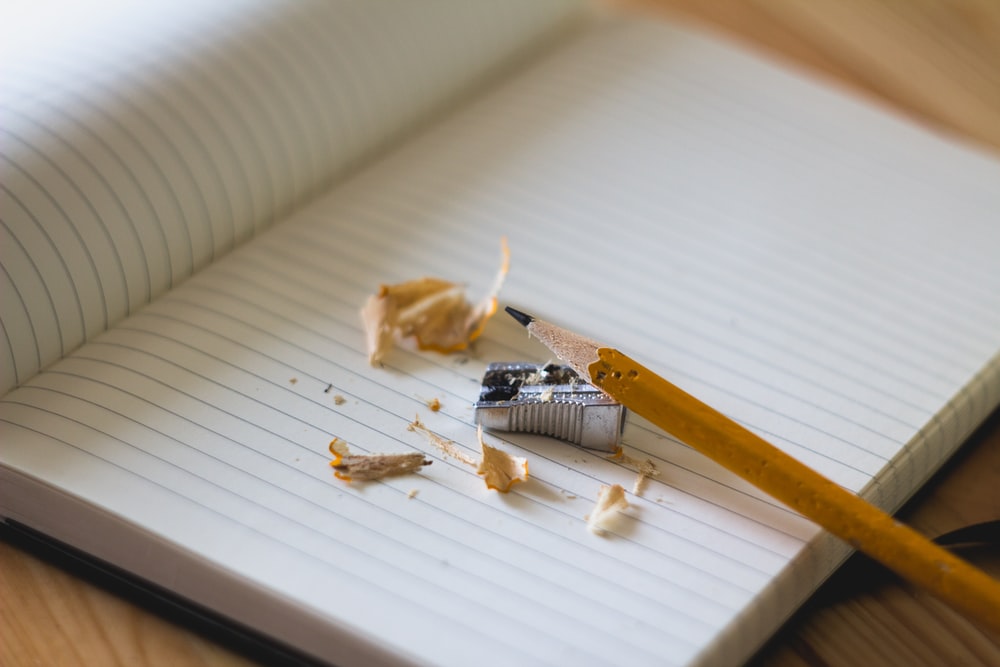 blank page in a journal with pencil and sharpener