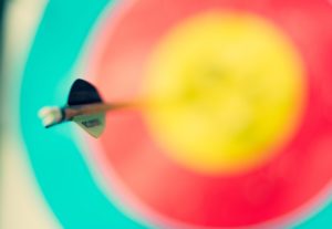 Dart hitting center of dart board