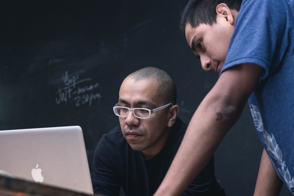 Teacher and student looking at the computer screen together