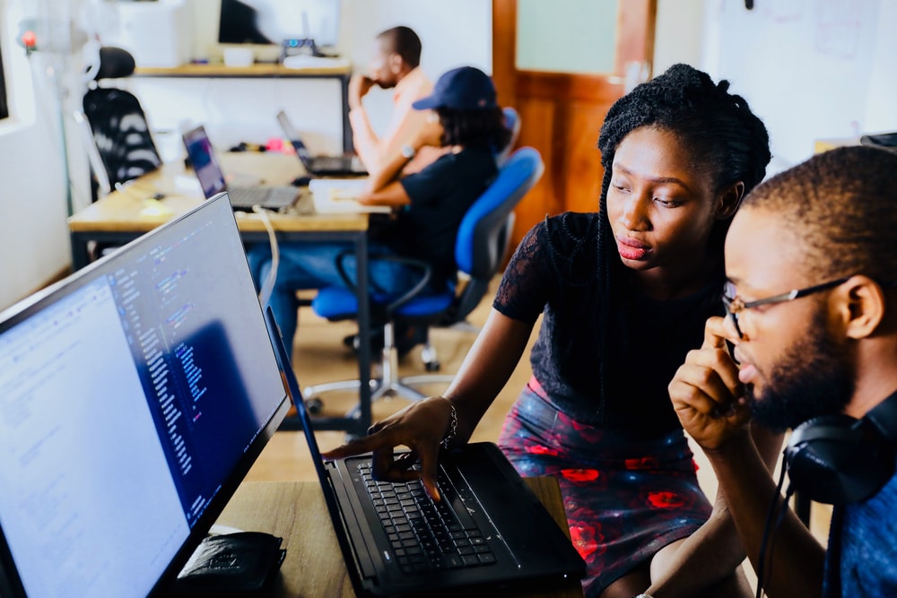 Teacher and student looking at a computer screen together